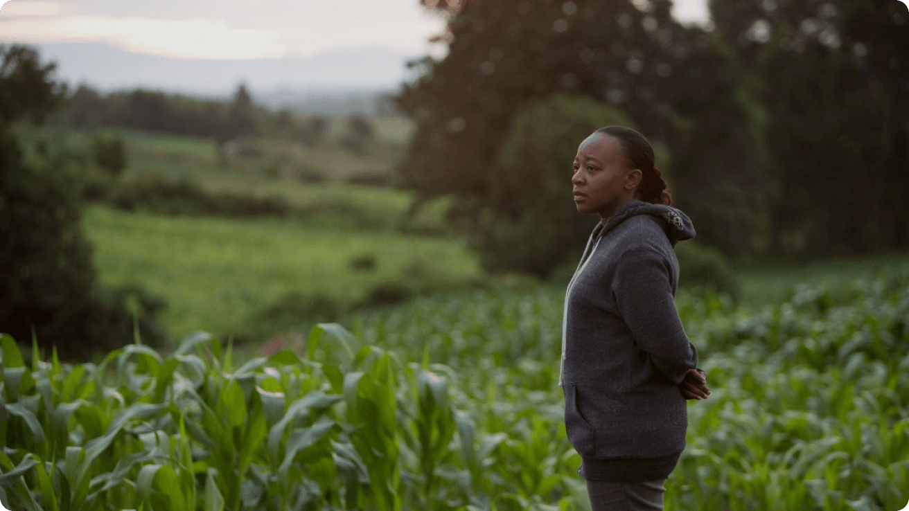Nuru Kenya Managing Director Pauline Wambeti surveys a farm in Kenya